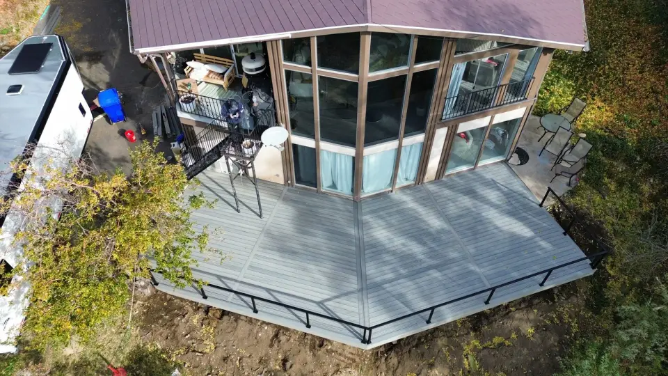 Completed ZBolt composite deck with picture-frame borders and black railings at a Utah home